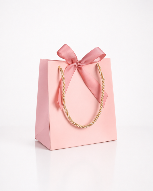 Bolsa de regalo de papel rosa con listón rosa